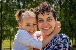 A young girl wrapping her arms around her mother