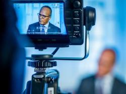 Photo of Lester Holt through camera viewfinder.