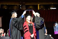 Photo of a PhD student during graduation ceremony