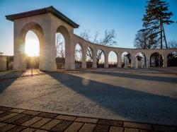 photo of arches on campus with morning light showing through