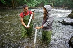 Photo of taking samples of sediment from the river bed.